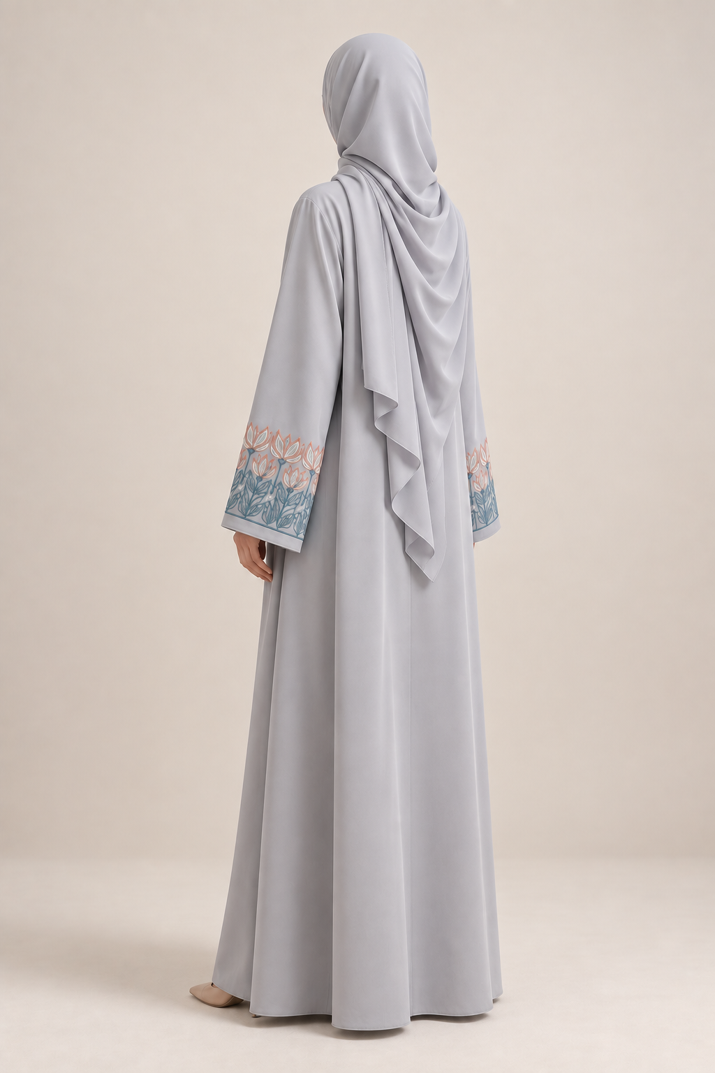 Close-up of embroidered cuff detail on light-grey Nida abaya